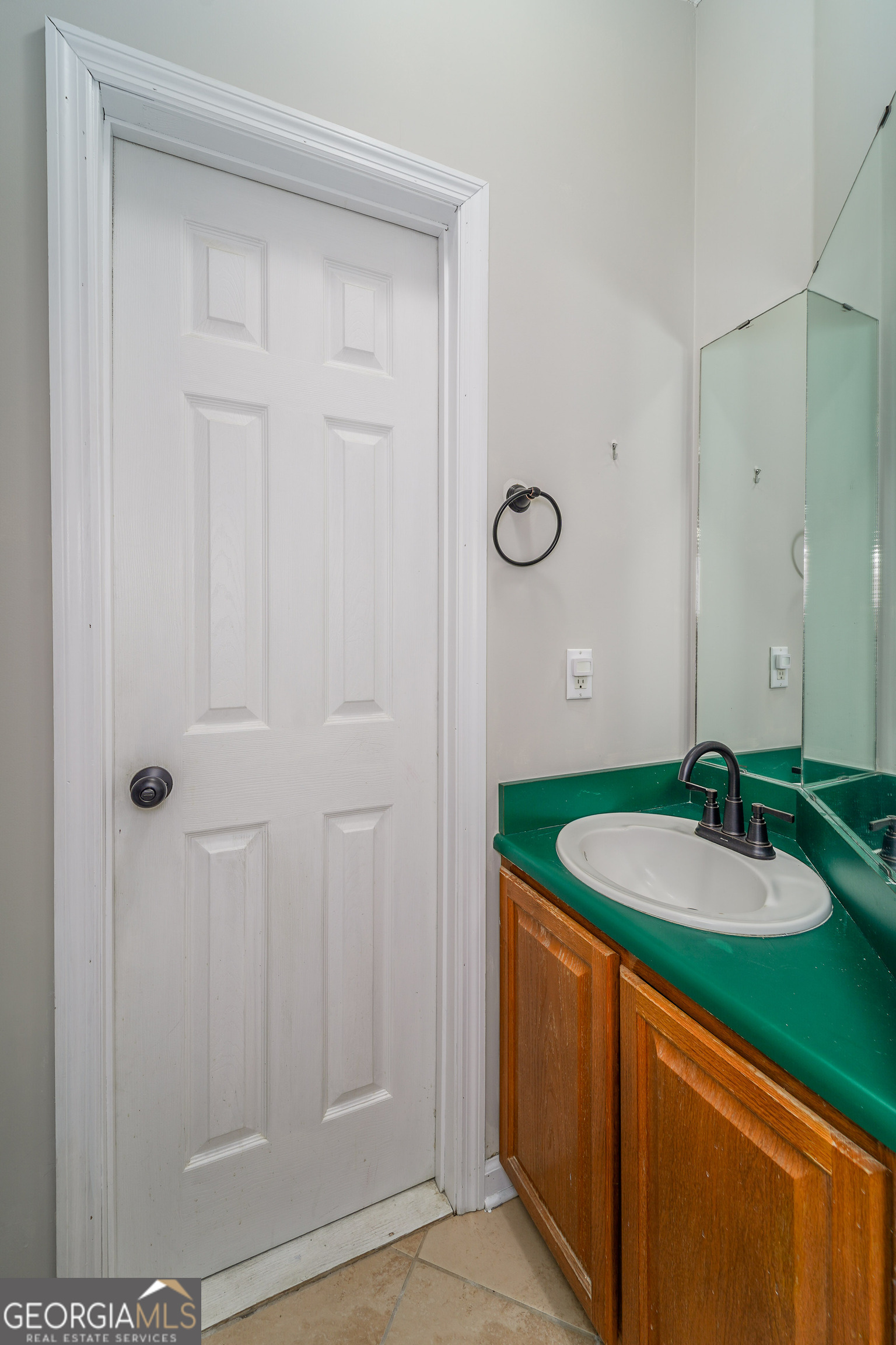 400 Smith Road Waycross, GA 31503 - Photo 17 of 25 a bathroom with a granite countertop sink and a mirror