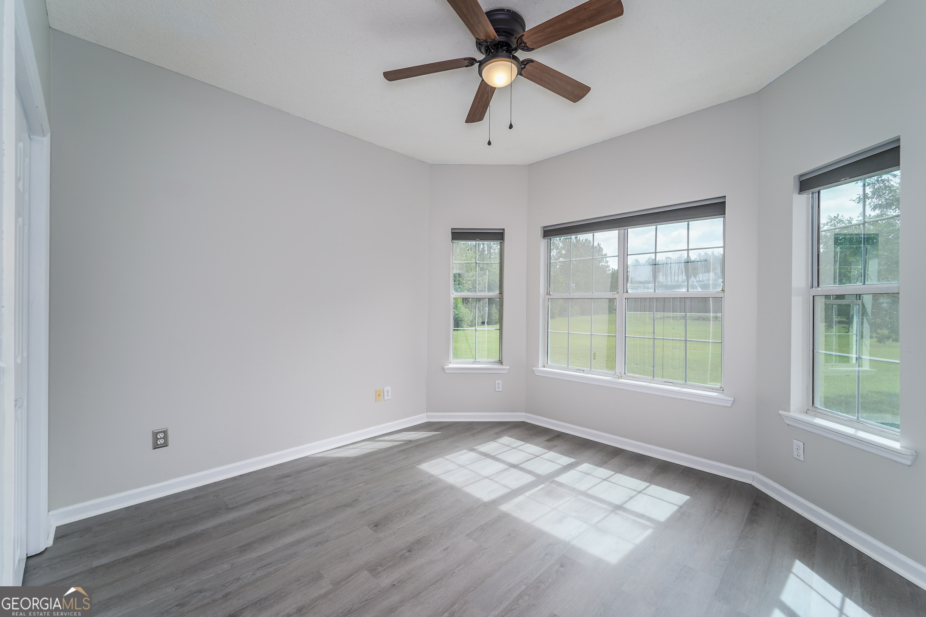 400 Smith Road Waycross, GA 31503 - Photo 24 of 25 a view of empty room with wooden floor and fan