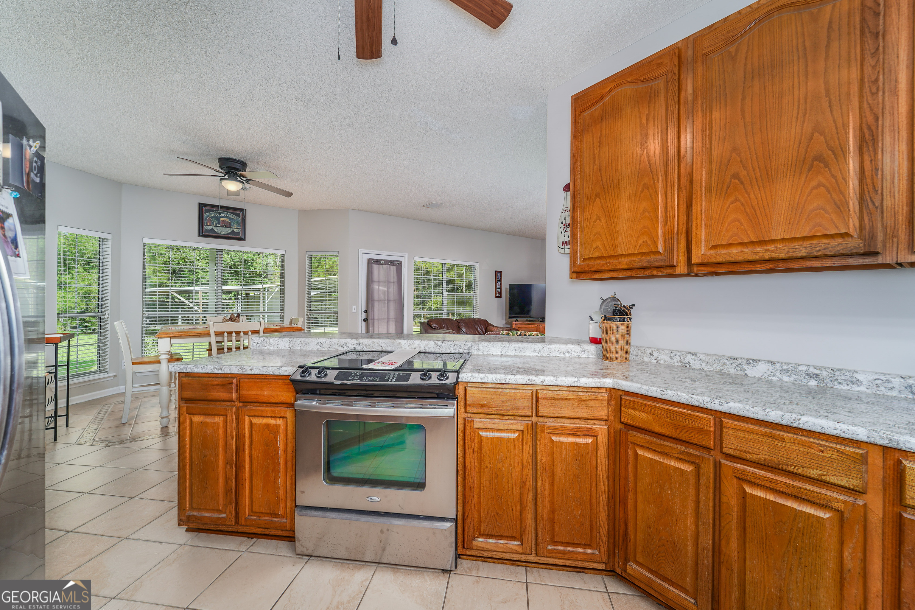 400 Smith Road Waycross, GA 31503 - Photo 10 of 25 a kitchen with stainless steel appliances granite countertop a stove a sink and a microwave