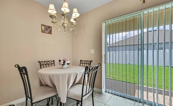 a view of a dining room with furniture and chandelier