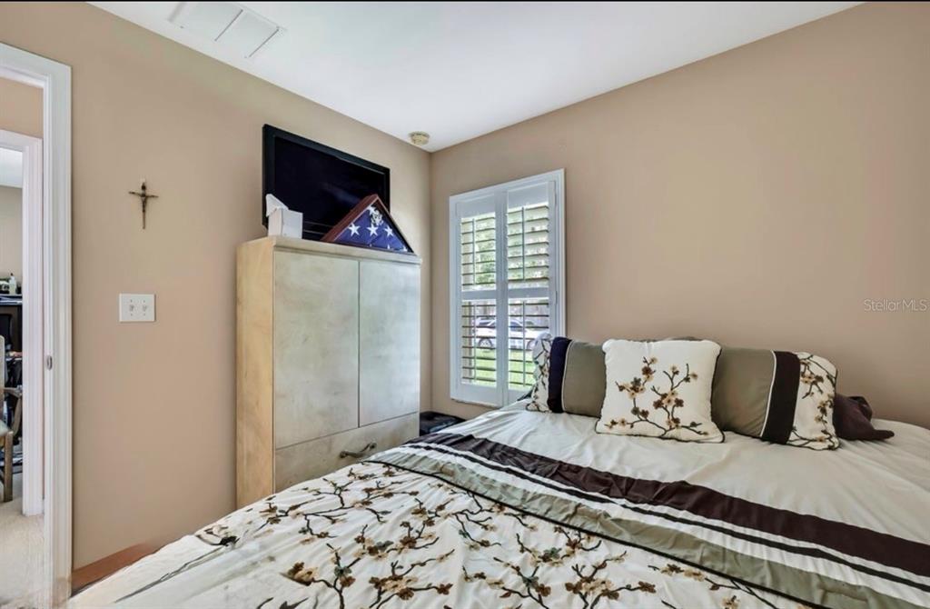 209 Winthrop Drive Spring Hill, FL 34609 - Photo 15 of 27 a bedroom with a bed and a window