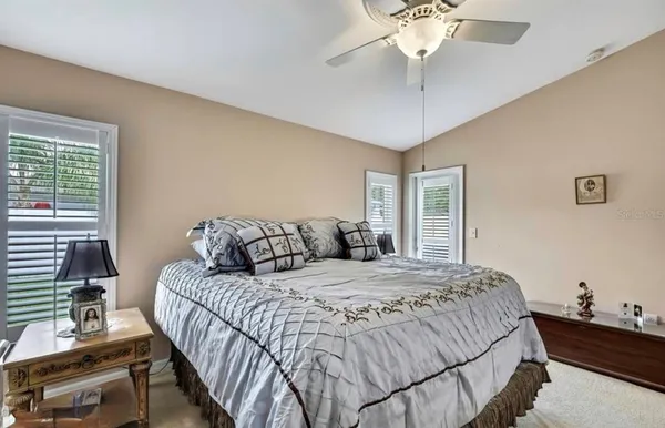 a bedroom with a bed and a chandelier