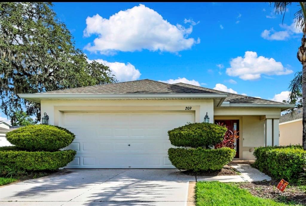 209 Winthrop Drive Spring Hill, FL 34609 - Photo 2 of 27 a view of a house with a garden