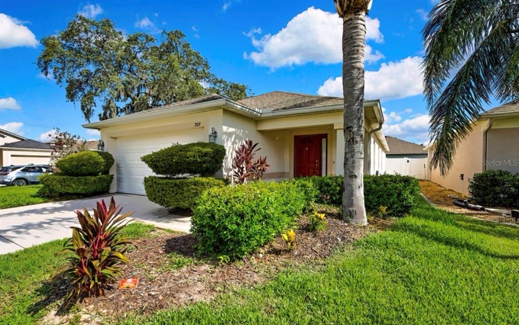 209 Winthrop Drive Spring Hill, FL 34609 - Photo 22 of 27 a front view of a house with a yard