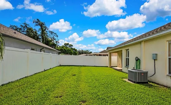 a view of a backyard with potted plants