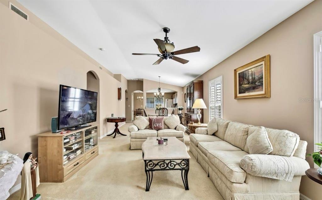 209 Winthrop Drive Spring Hill, FL 34609 - Photo 4 of 27 a living room with furniture and a flat screen tv