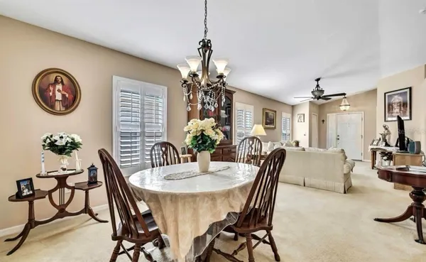a dining room with furniture and a chandelier