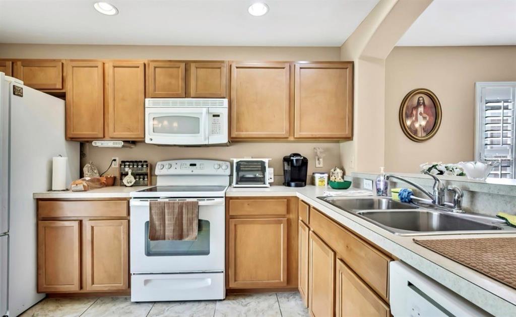 209 Winthrop Drive Spring Hill, FL 34609 - Photo 10 of 27 a kitchen with a sink stove and cabinets