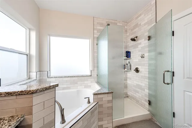 a bathroom with a bathtub sink and mirror