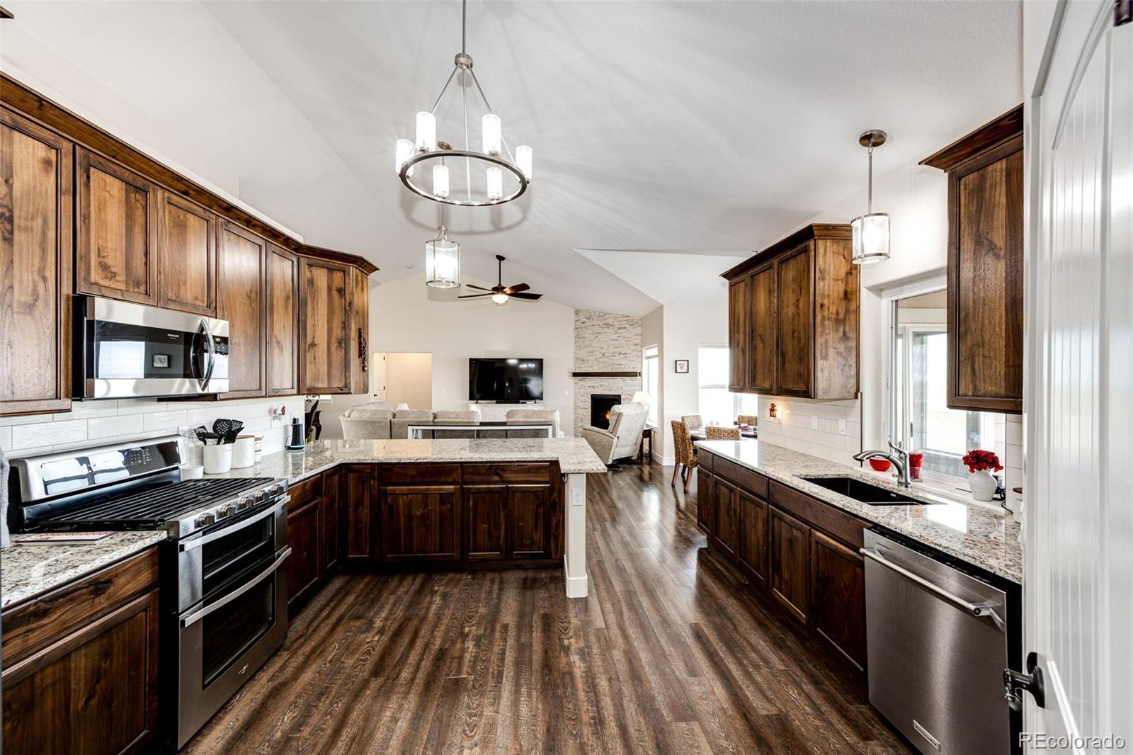 4820 Kiowa-Bennett Road Bennett, CO 80102 - Photo 7 of 29 a kitchen with stainless steel appliances a sink stove and refrigerator