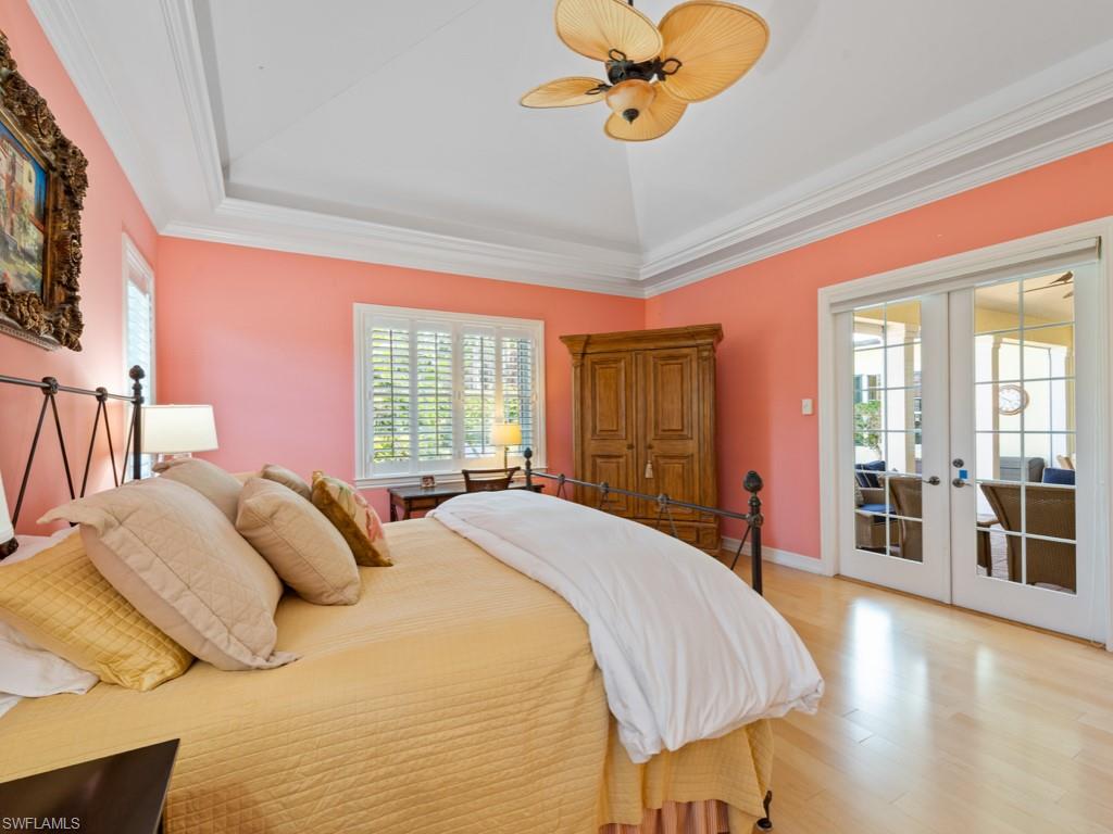 505 Harbour Drive Naples, FL 34103 - Photo 11 of 37 a spacious bedroom with a large bed and a chandelier