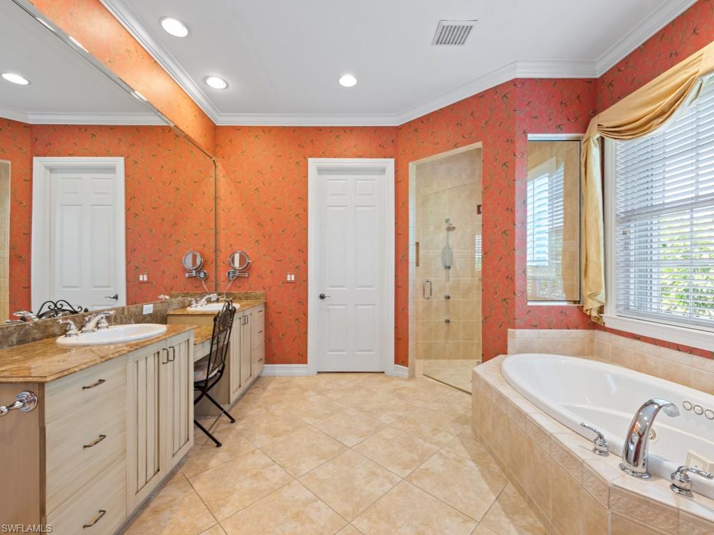 505 Harbour Drive Naples, FL 34103 - Photo 13 of 37 a spacious bathroom with a double vanity sink a mirror and a bathtub