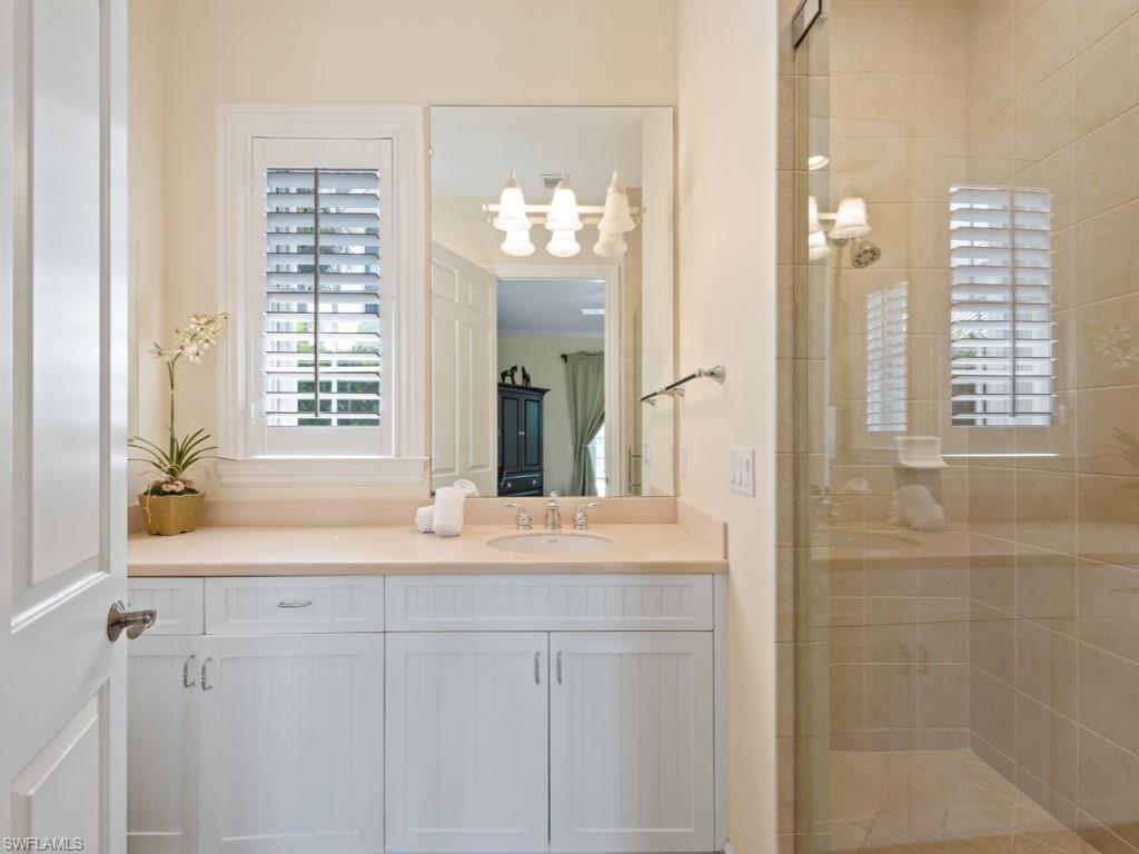 505 Harbour Drive Naples, FL 34103 - Photo 14 of 37 a bathroom with a double vanity sink and a mirror