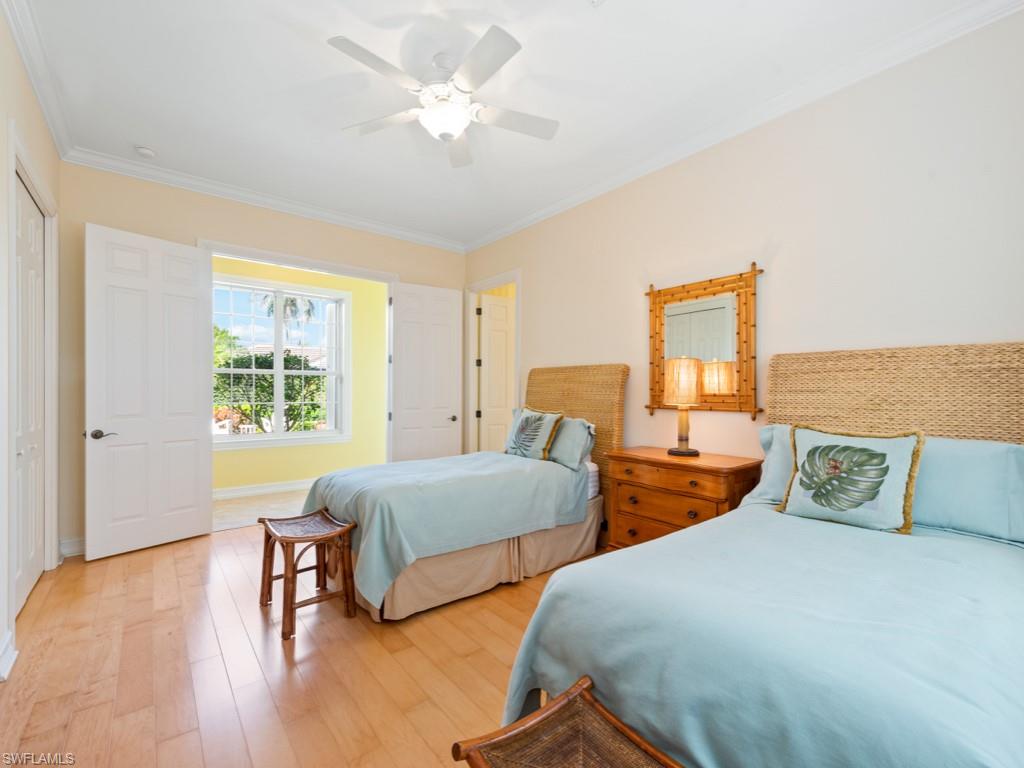 505 Harbour Drive Naples, FL 34103 - Photo 17 of 37 a bedroom with two beds and a lamp