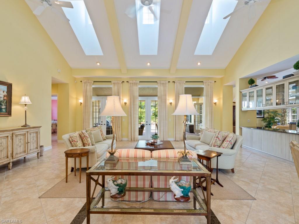 505 Harbour Drive Naples, FL 34103 - Photo 19 of 37 a living room with furniture a table and chairs next to a window