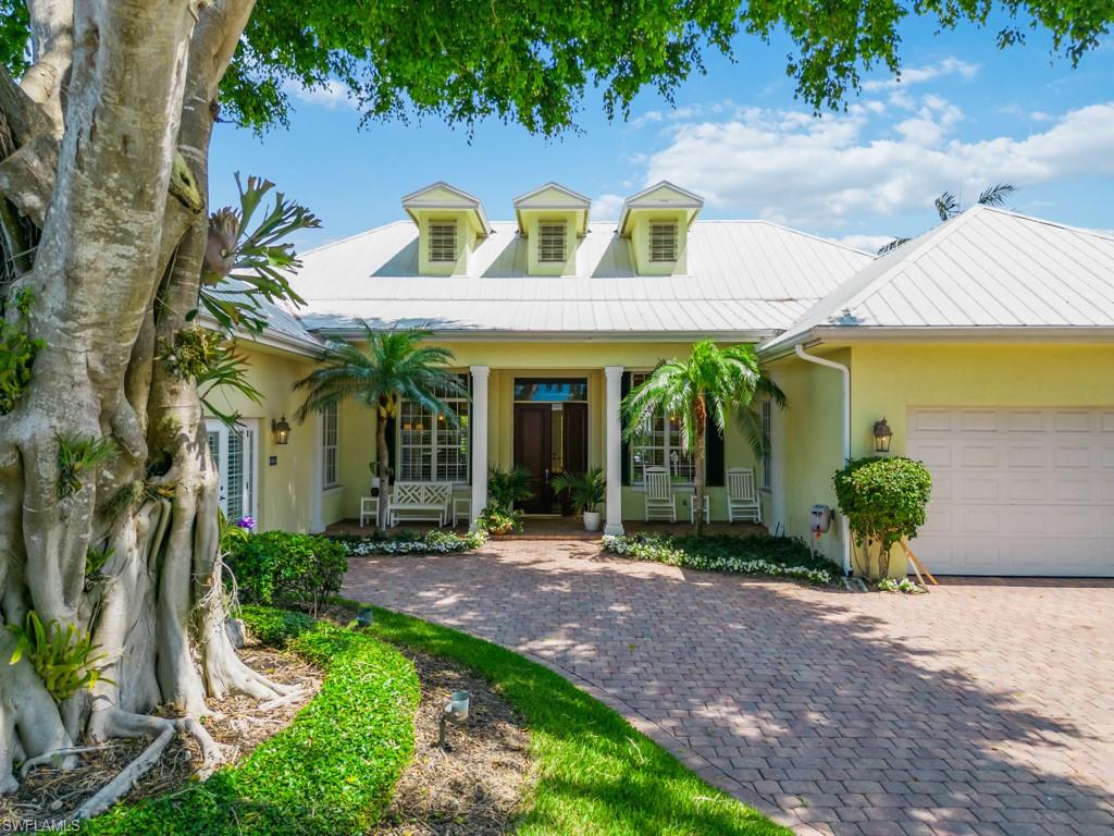 505 Harbour Drive Naples, FL 34103 - Photo 2 of 37 a front view of a house with garden