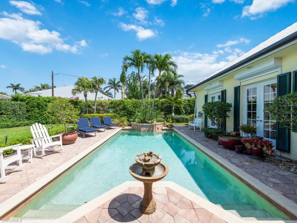 505 Harbour Drive Naples, FL 34103 - Photo 26 of 37 a view of swimming pool with outdoor seating