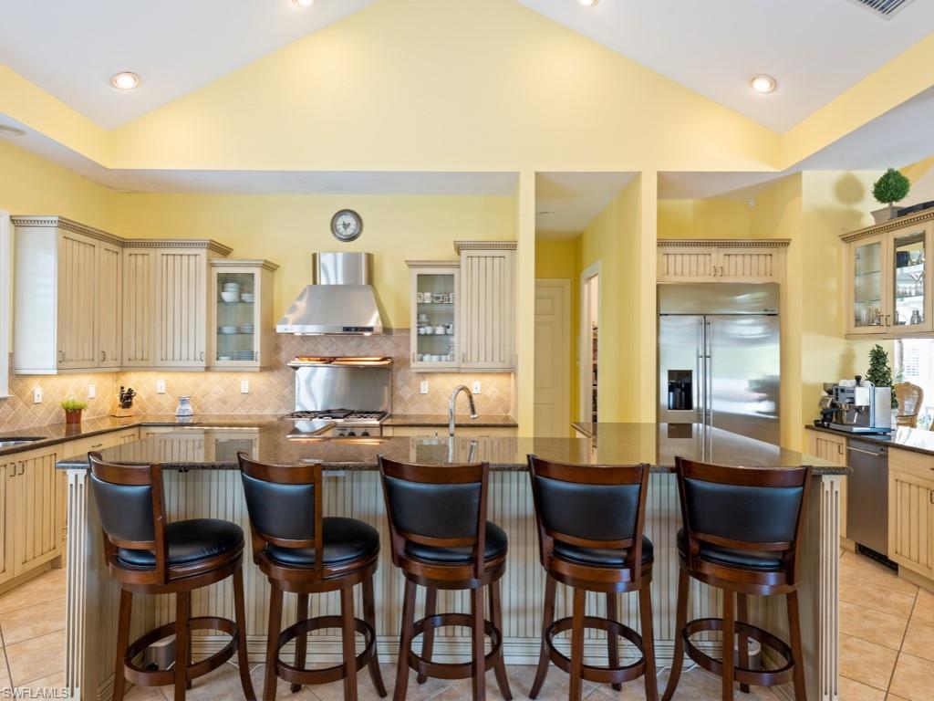 505 Harbour Drive Naples, FL 34103 - Photo 5 of 37 a kitchen with a dining table chairs and white cabinets