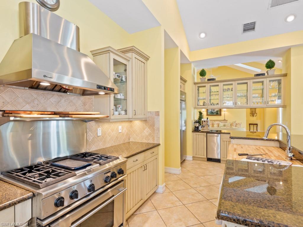505 Harbour Drive Naples, FL 34103 - Photo 6 of 37 a kitchen with stainless steel appliances granite countertop a stove and a sink
