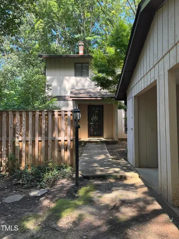 a backyard of a house with table and chairs