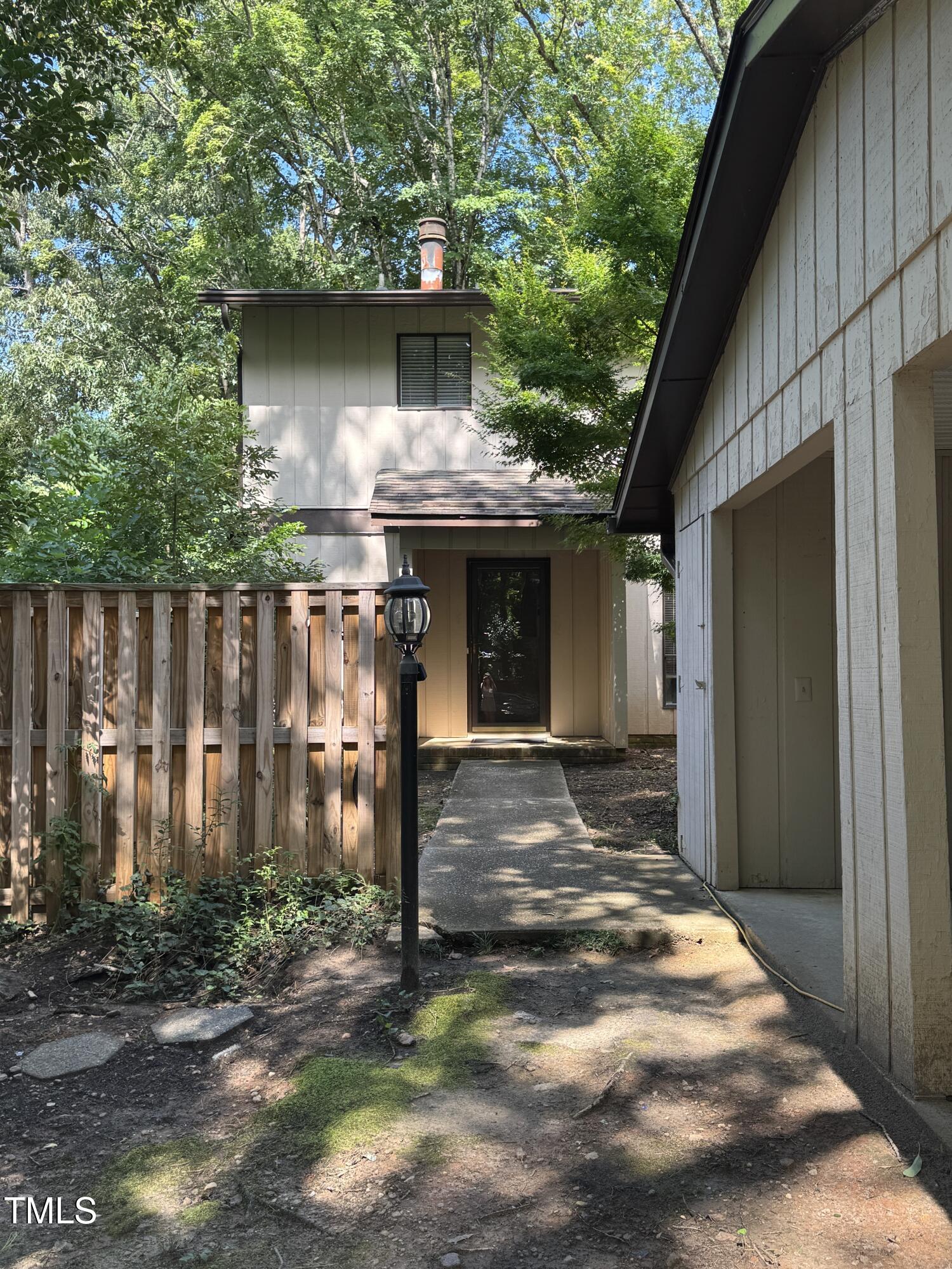 a backyard of a house with table and chairs