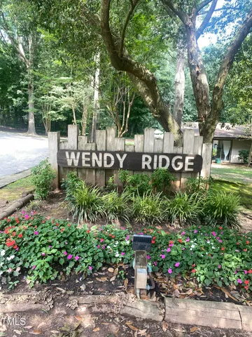 a view of a sign board with flower plants