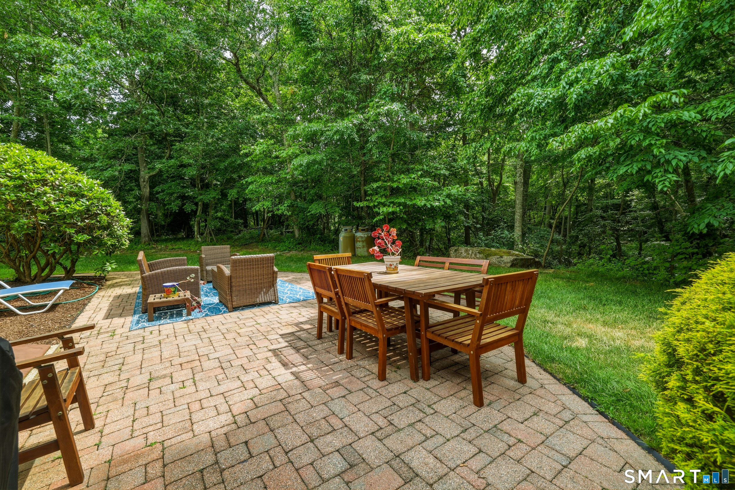 122 Lower Road Guilford, CT 06437 - Photo 28 of 39 A paver patio just off the sunporch provides the perfect setting for summertime entertaining, morning coffee, or simply relaxing while enjoying the peaceful natural surroundings.