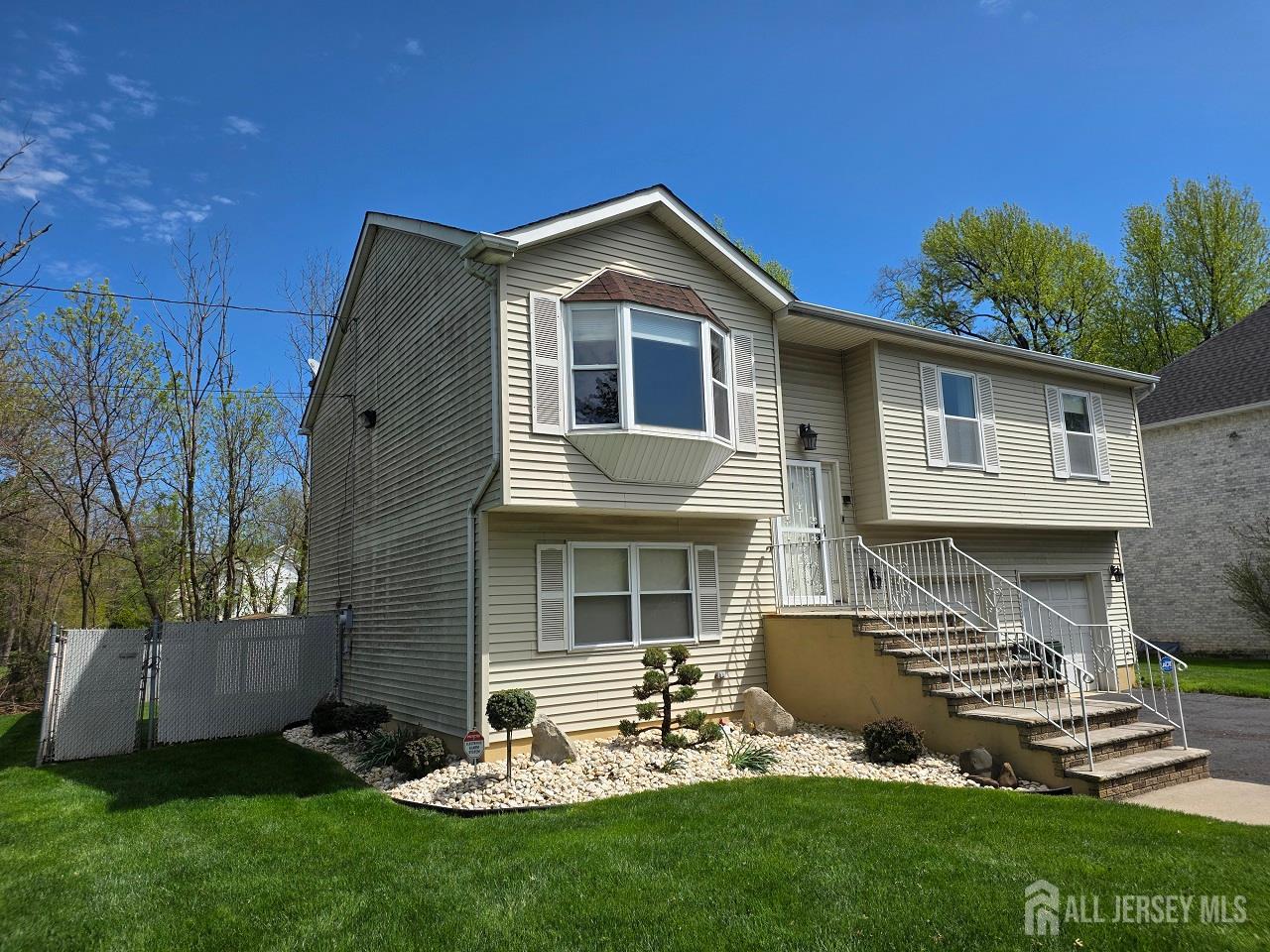 1 Wakefield Drive Edison, NJ 08820 - Photo 2 of 29 a front view of a house with a garden