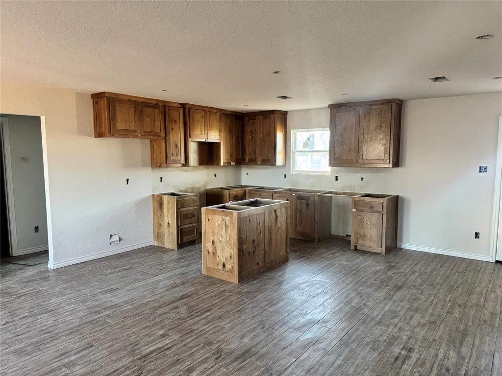 1012 Morgan Court Springtown, TX 76082 - Photo 2 of 4 a kitchen with stainless steel appliances granite countertop a stove a sink and a refrigerator