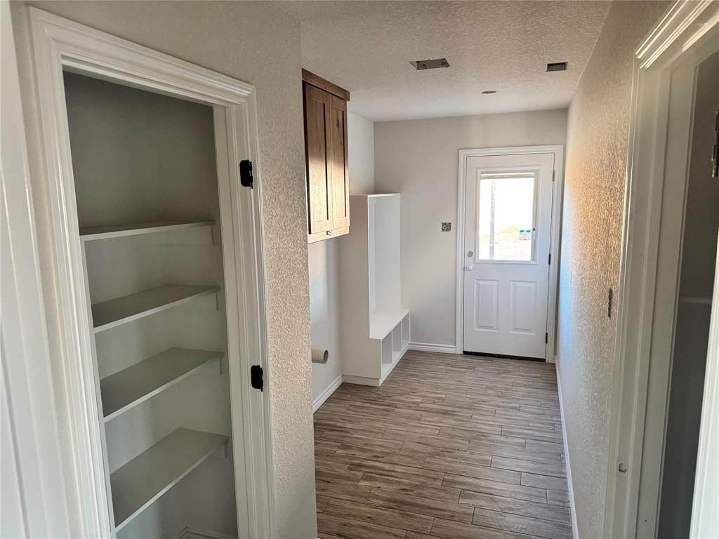 1012 Morgan Court Springtown, TX 76082 - Photo 4 of 4 a view of a hallway with wooden floor