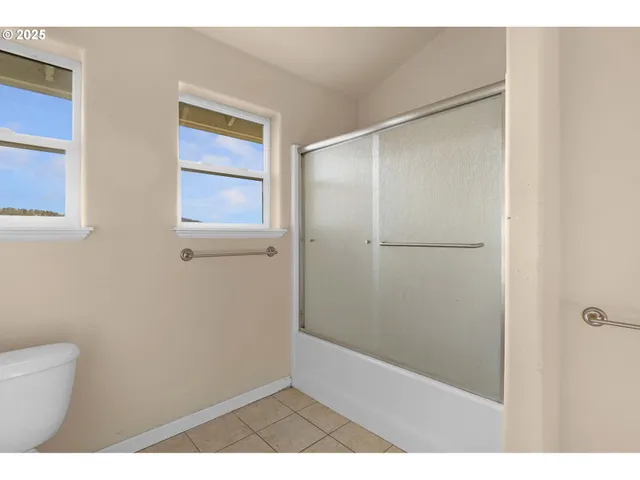 a bathroom with a shower and a toilet