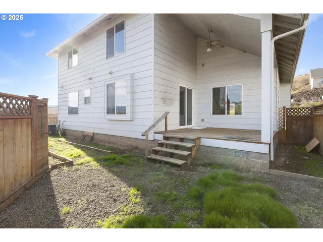a view of a house with backyard and a chair