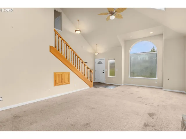 a view of an empty room with stairs