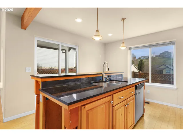 a kitchen with a sink a counter space and a refrigerator