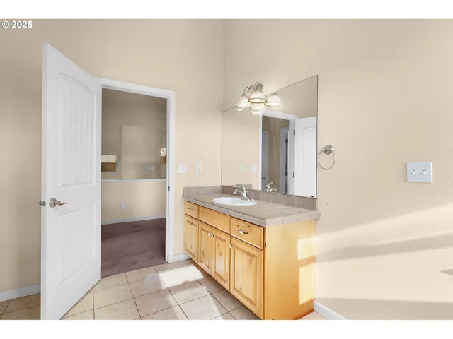 a bathroom with a sink a mirror and a shower