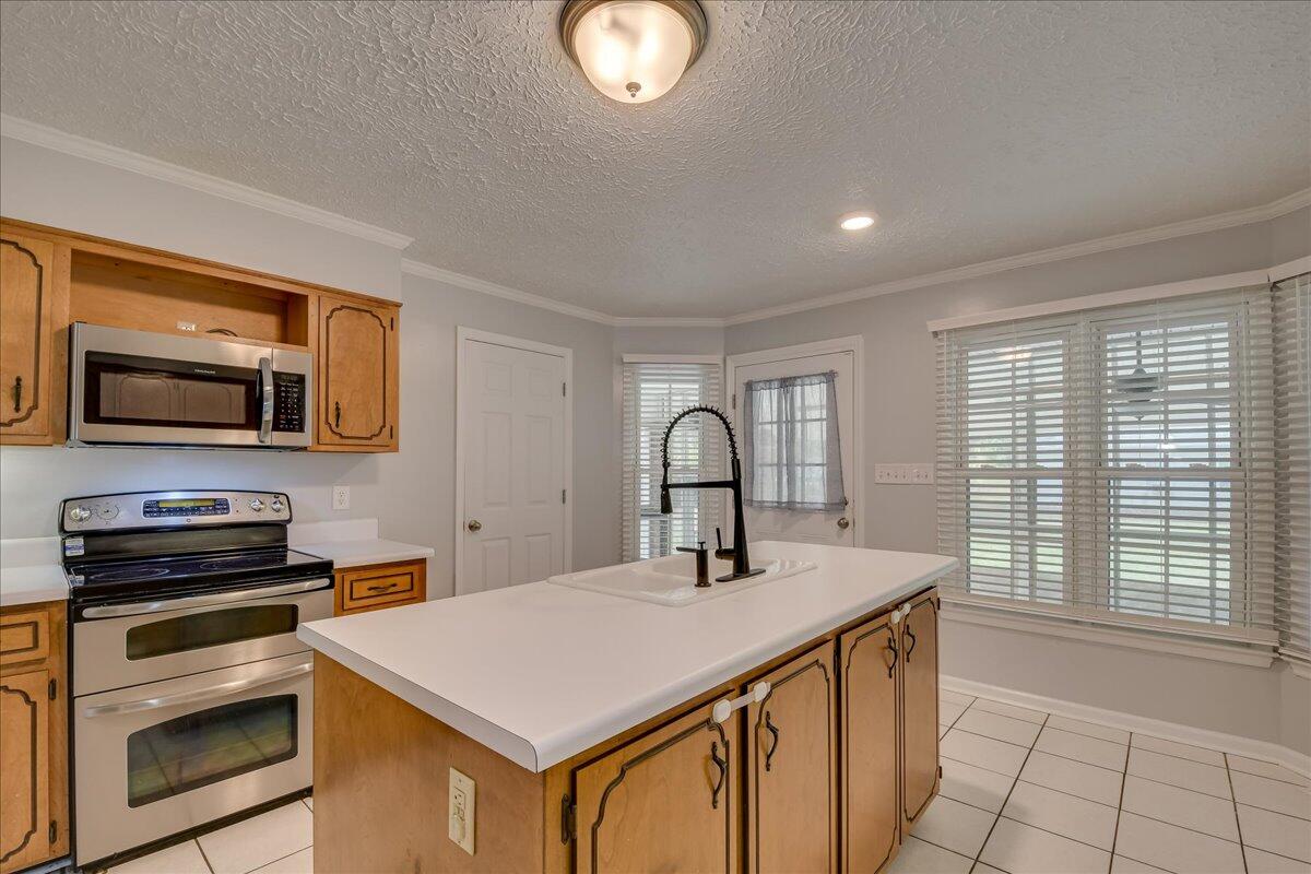 165 Morris Road Thomson, GA 30824 - Photo 11 of 26 Spacious kitchen with new dishwasher, microwave, stainless refrigerator, bar seating, pantry and plenty of cabinet storage!