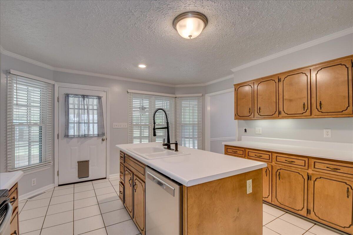 165 Morris Road Thomson, GA 30824 - Photo 12 of 26 Spacious kitchen with new dishwasher, microwave, stainless refrigerator, bar seating, pantry and plenty of cabinet storage!