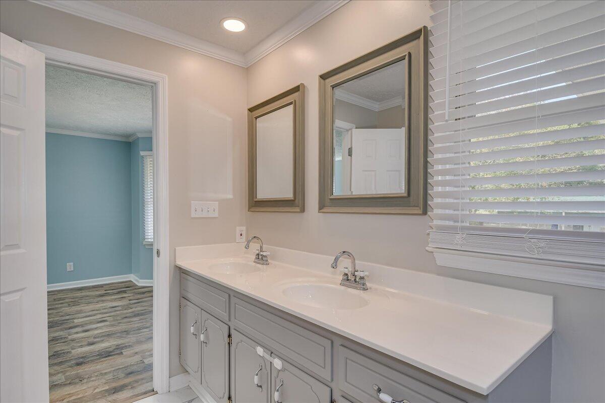 165 Morris Road Thomson, GA 30824 - Photo 15 of 26 Primary ensuite bathroom with double-sink vanity, tile shower, updated lighting and mirrors.