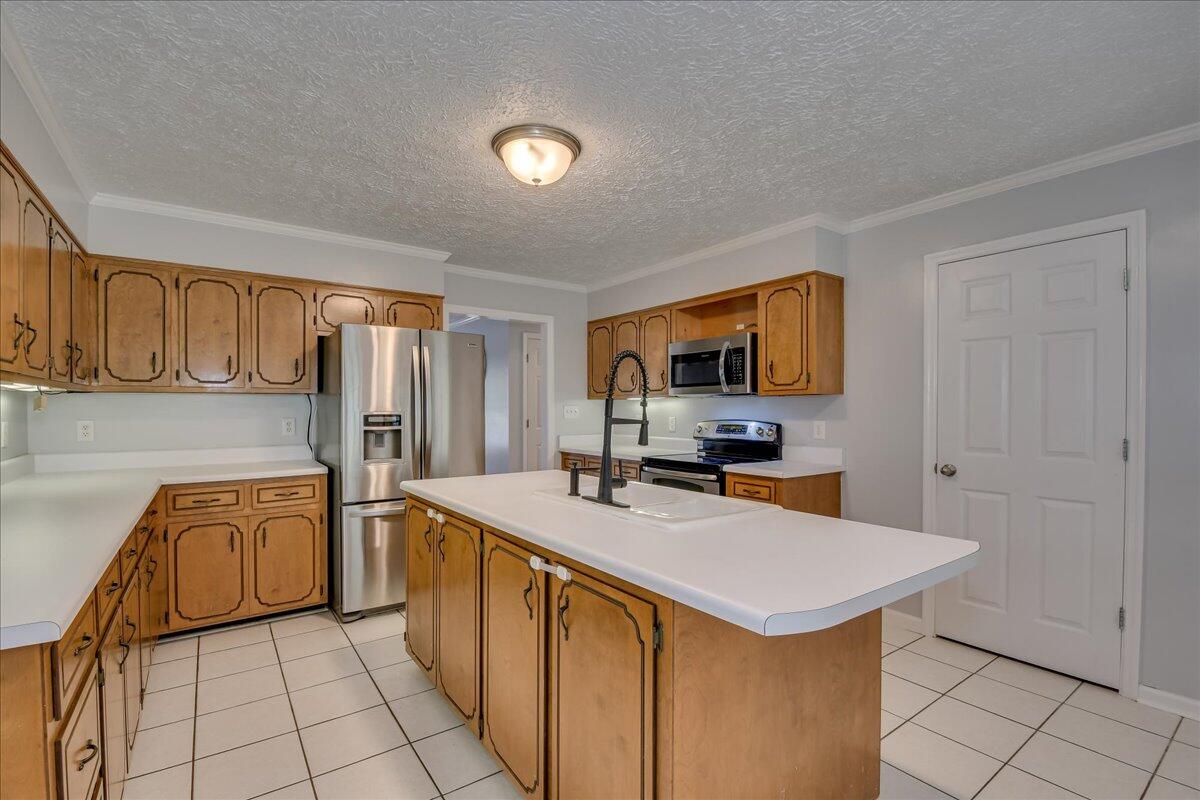 165 Morris Road Thomson, GA 30824 - Photo 4 of 26 Spacious kitchen with new dishwasher, microwave, stainless refrigerator, bar seating, pantry and plenty of cabinet storage!