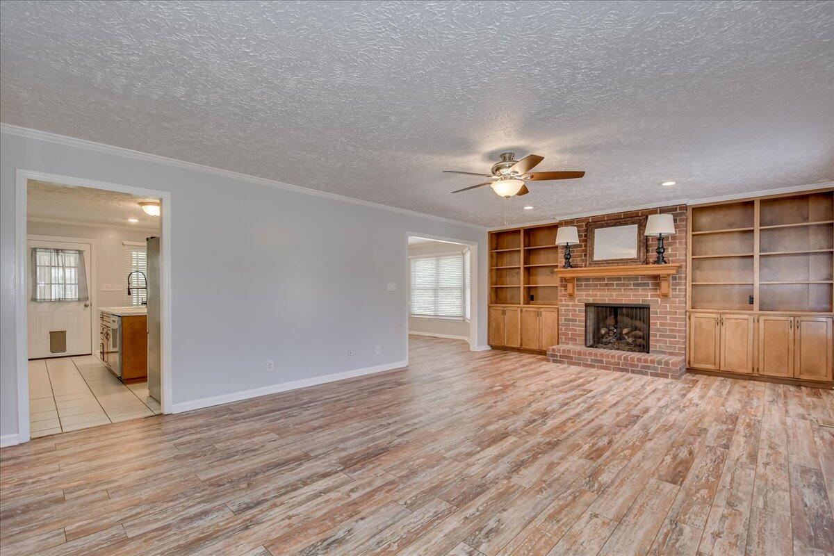 165 Morris Road Thomson, GA 30824 - Photo 6 of 26 Lovely brick fireplace with beautiful built-in shelves.