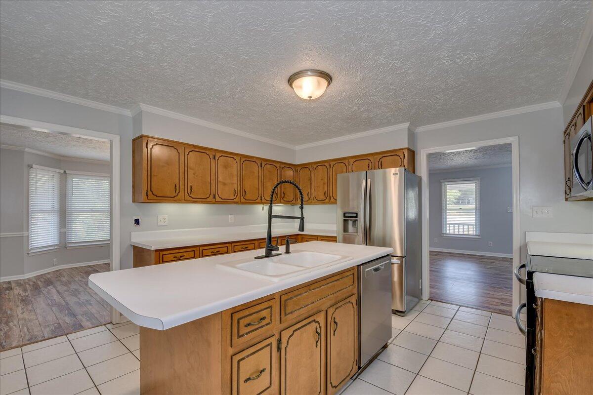 165 Morris Road Thomson, GA 30824 - Photo 10 of 26 Spacious kitchen with new dishwasher, microwave, stainless refrigerator, bar seating, pantry and plenty of cabinet storage!