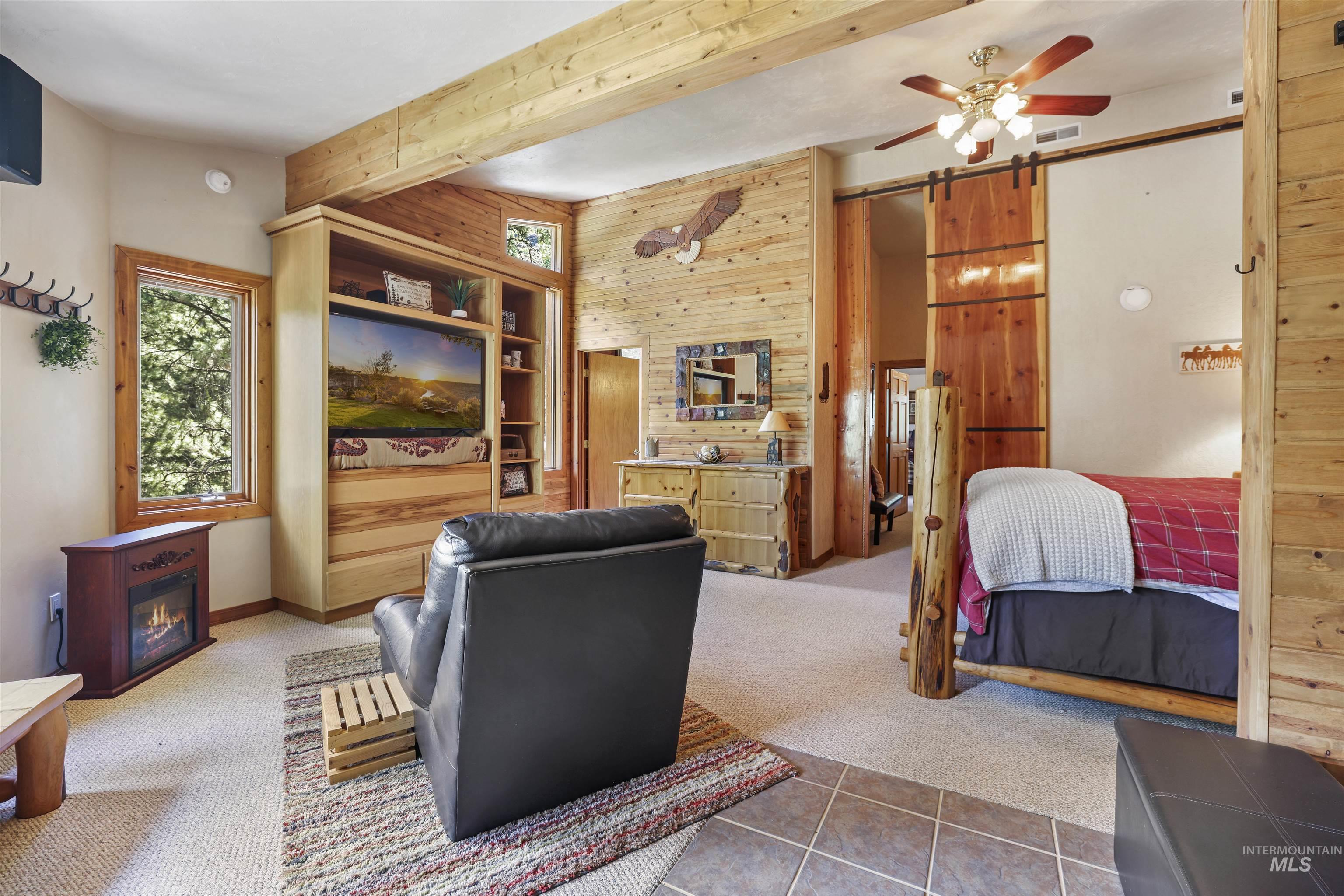 224 Dakota Road Mountain Home, ID 83647 - Photo 16 of 50 Interior space featuring extensive wood paneling and exposed wood beams