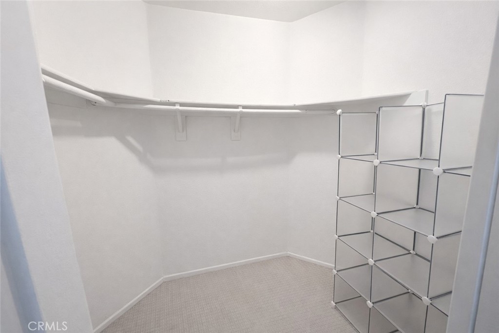 9275 Rancho Park Place Rancho Cucamonga, CA 91730 - Photo 19 of 33 Closet in Primary. Image has been altered and does not portray the property as it exists today. Certain elements may have been deleted, color, brightness and contrast have been edited.