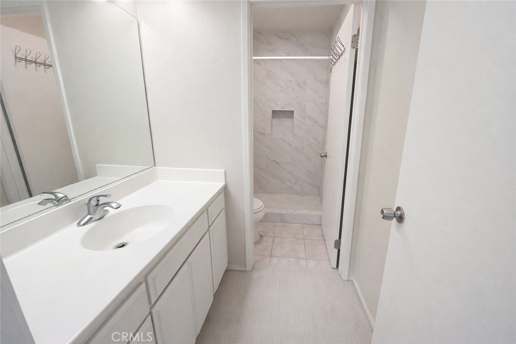 9275 Rancho Park Place Rancho Cucamonga, CA 91730 - Photo 21 of 33 Shared Bathroom Upstairs. Image has been altered and does not portray the property as it exists today. Certain elements may have been deleted, color, brightness and contrast have been edited.