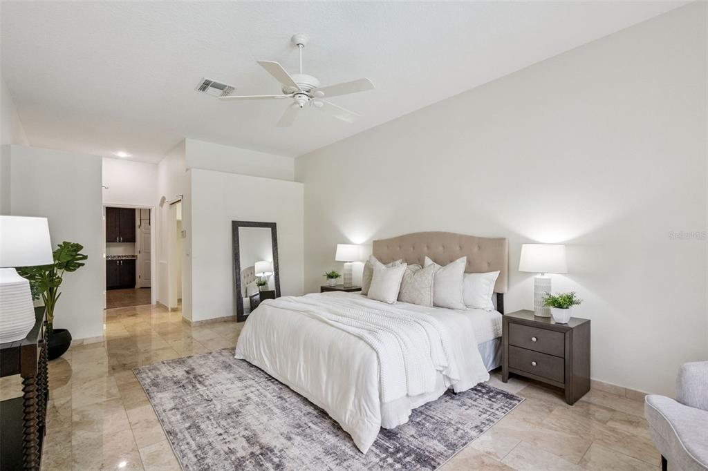 2541 Teton Stone Run Orlando, FL 32828 - Photo 34 of 82 a bedroom with a bed and a chandelier