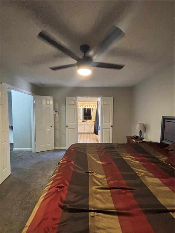 4949 Penscot Way Stone Mountain, GA 30088 - Photo 30 of 40 a bedroom with a large bed and a chandelier