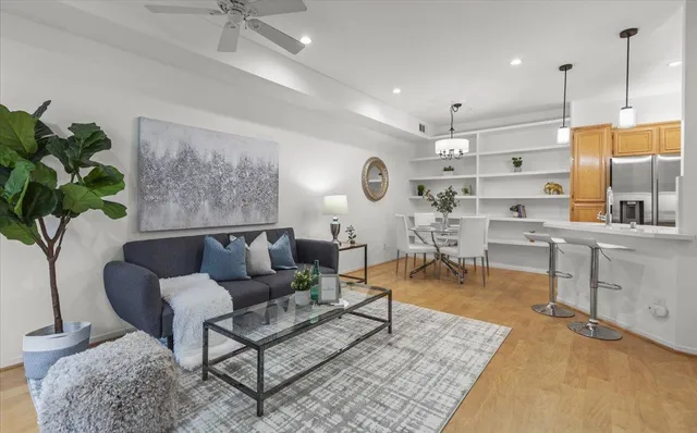 a living room with furniture a rug and a chandelier