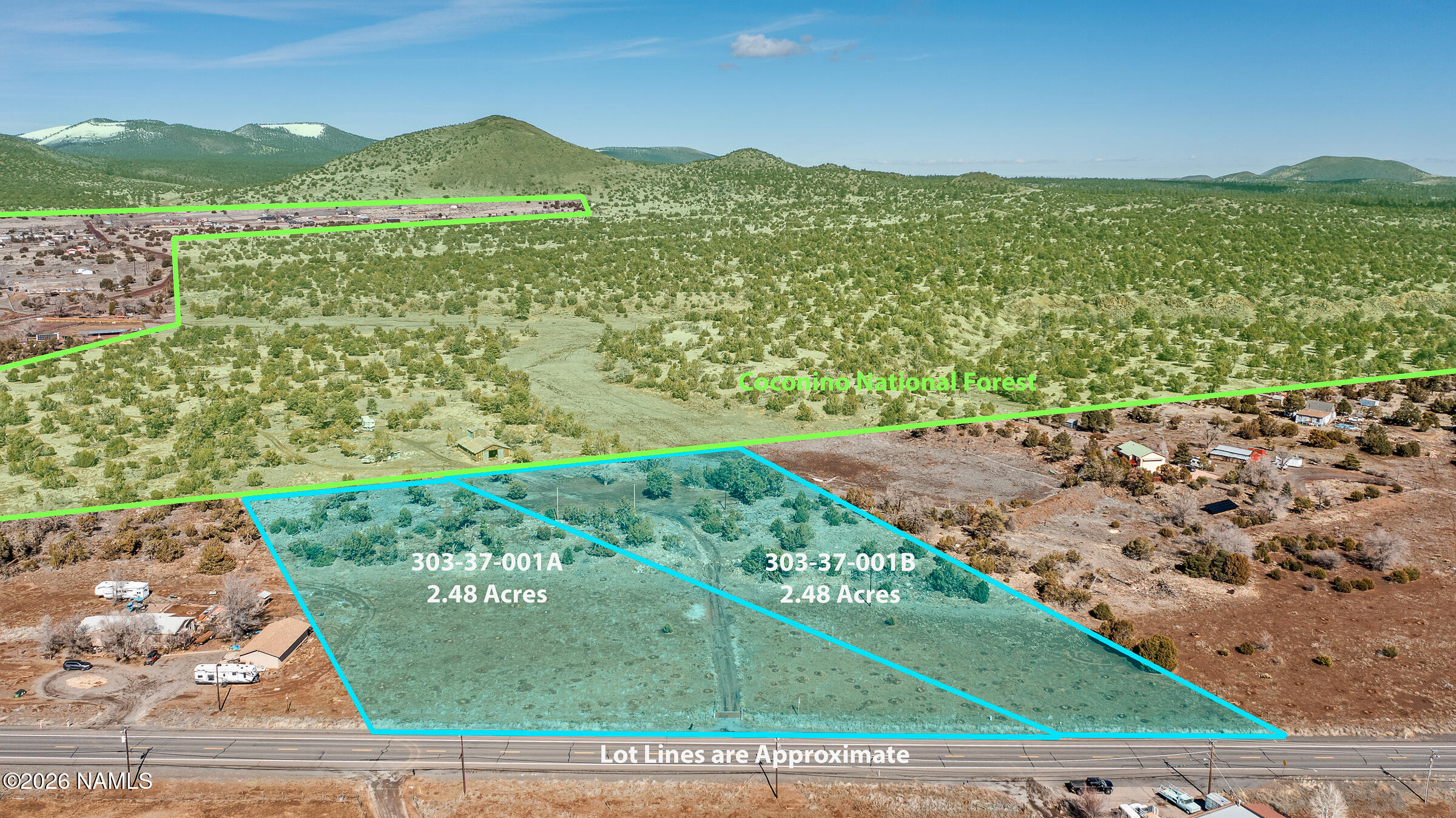10055 Townsend-Winona Road Flagstaff, AZ 86004 - Photo 1 of 24 a view of a lush green field with mountains in the background