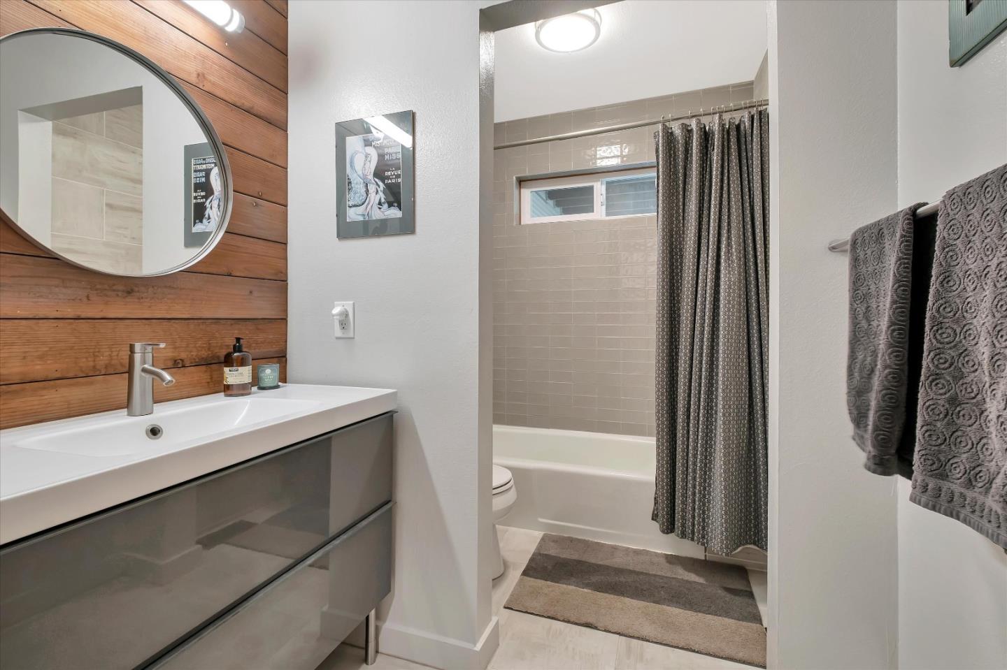 1573 North Rodeo Gulch Road Soquel, CA 95073 - Photo 17 of 40 a bathroom with a sink a mirror and a shower