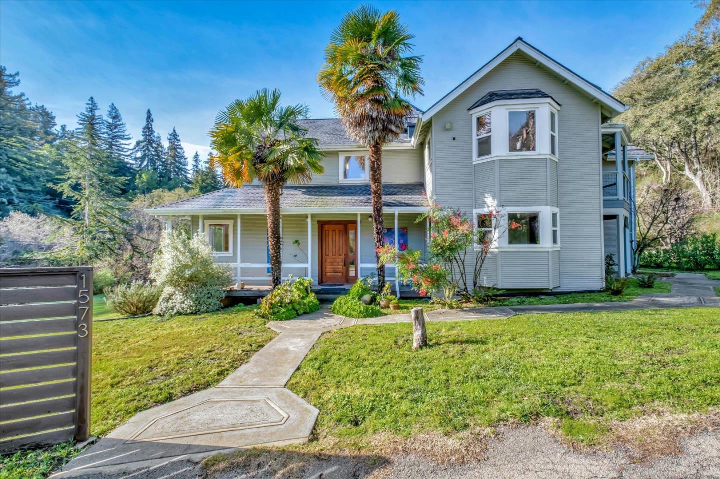 1573 North Rodeo Gulch Road Soquel, CA 95073 - Photo 2 of 40 a front view of a house with a yard and porch